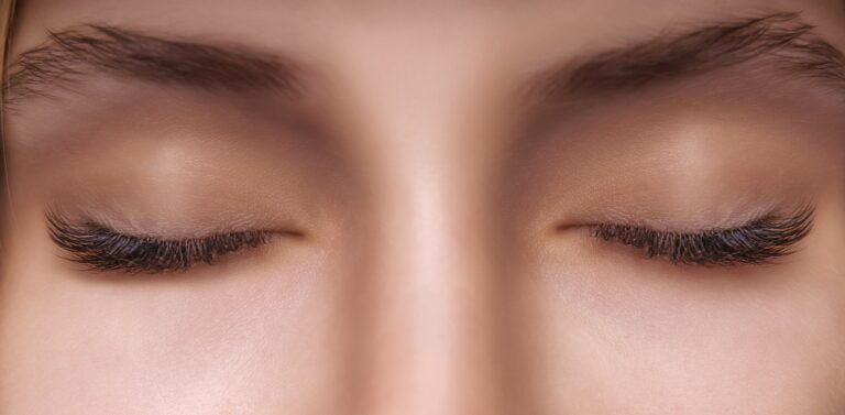 Eyelash Extension Procedure Woman Eye with Long Eyelashes Close up selective focus